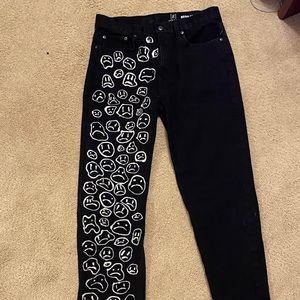 self designed sad face print black jeans